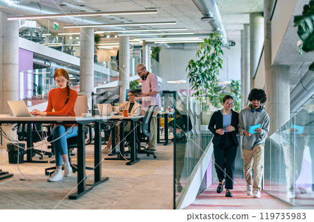 In a modern startup office, a diverse group of young professionals collaboratively tackles various business problems and challenges, surrounded by their engaged colleagues, fostering innovation and 119735983