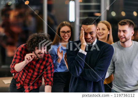 A group of young business people have fun playing interesting games while taking a break from work in a modern office. Selective focus  119736112