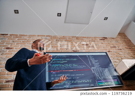 African American businessman delivers a compelling presentation of his business strategy to his colleagues, fostering collaboration and forward thinking African American businessman delivers a compelling presentation of his business strategy to his colleagues, fostering collaboration and forward thinking 119736219