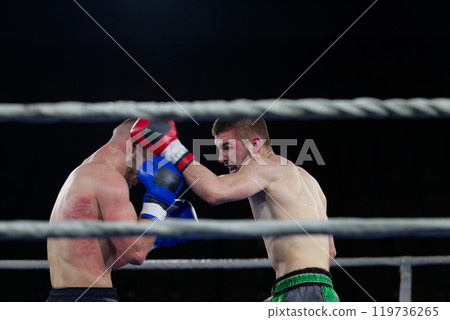Fierce boxing match showcases athletes' power and skill. 119736265