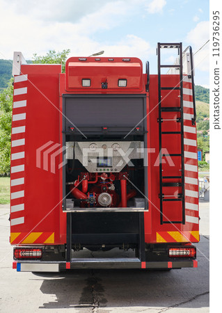 Close-up of essential firefighting equipment on a modern firetruck, showcasing tools and gear ready for emergency response to hazardous fire situations Close-up of essential firefighting equipment on a modern firetruck, showcasing tools and gear ready for emergency response to hazardous fire situations 119736295