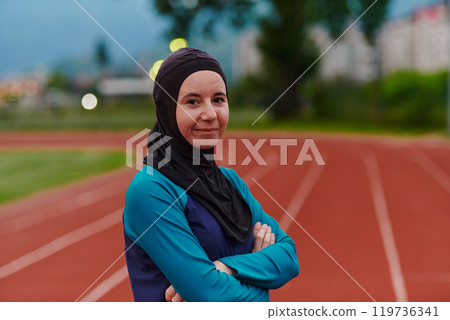 A Muslim woman with a burqa, an Islamic sportswoman resting after a vigorous training session on the marathon course. A hijab woman is preparing for a marathon competition A Muslim woman with a burqa, an Islamic sportswoman resting after a vigorous training session on the marathon course. A hijab woman is preparing for a marathon competition 119736341