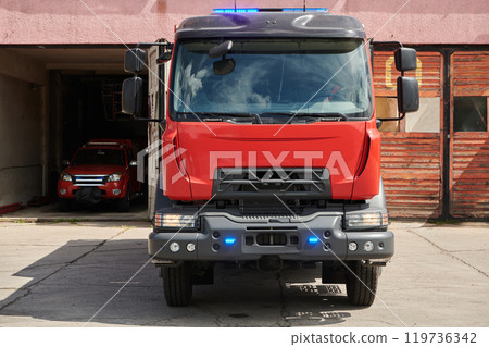 A state-of-the-art firetruck, equipped with advanced rescue technology, stands ready with its skilled firefighting team, prepared to intervene and respond rapidly to emergencies, ensuring the safety A state-of-the-art firetruck, equipped with advanced rescue technology, stands ready with its skilled firefighting team, prepared to intervene and respond rapidly to emergencies, ensuring the safety 119736342