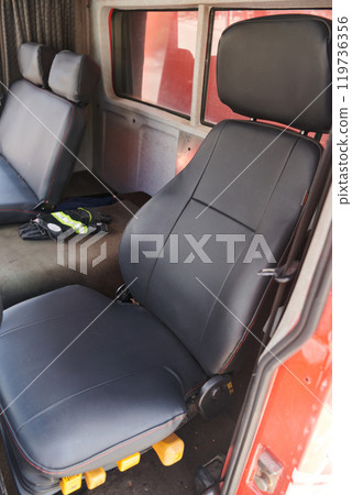 The close-up capture reveals the intricate details of the ergonomic seats and high-tech interior of a modern firefighting truck, showcasing a perfect blend of functionality and safety features 119736356