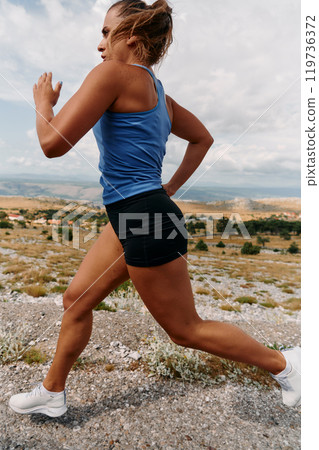 Empowered Runner Embracing Nature's Beauty on a Serene Morning Trail. Empowered Runner Embracing Nature's Beauty on a Serene Morning Trail. 119736372