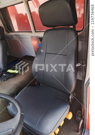 The close-up capture reveals the intricate details of the ergonomic seats and high-tech interior of a modern firefighting truck, showcasing a perfect blend of functionality and safety features The close-up capture reveals the intricate details of the ergonomic seats and high-tech interior of a modern firefighting truck, showcasing a perfect blend of functionality and safety features 119736468
