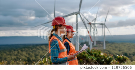 Female engineers using tablets to monitor and manage wind turbine operations on site.Generated image 119736506