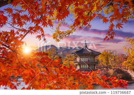 Gyeongbokgung Palace in autumn in sunset with maple leaves in the foreground, South Korea. Gyeongbokgung Palace in autumn in sunset with maple leaves in the foreground, South Korea. 119736687