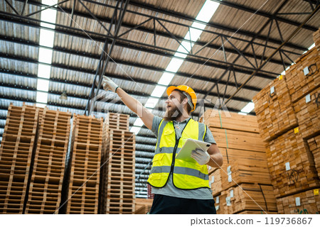 Worker Man with a bearded wearing safety uniform hard hat using tablet working checking quality Worker Man with a bearded wearing safety uniform hard hat using tablet working checking quality 119736867