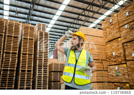 Worker Man with a bearded wearing safety uniform hard hat holding tablet Worker Man with a bearded wearing safety uniform hard hat holding tablet 119736868