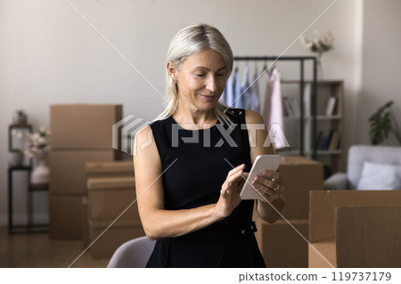 Aged lady online shop vendor hold cell type message 119737179