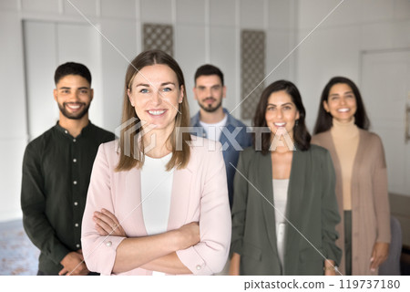 Happy Caucasian company director woman standing in front of employees Happy Caucasian company director woman standing in front of employees 119737180