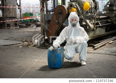 Chemical inspector female worker wearing protective mask and hazmat suit examining chemistry in industrial. Analysing harmful substances to human body and environment. 119737190