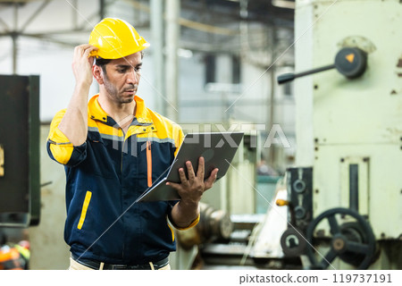Industrial man engineer wear uniform and helmet using laptop are checking system machine at factory. manager technician manufacturing. Workers industrial factory. 119737191