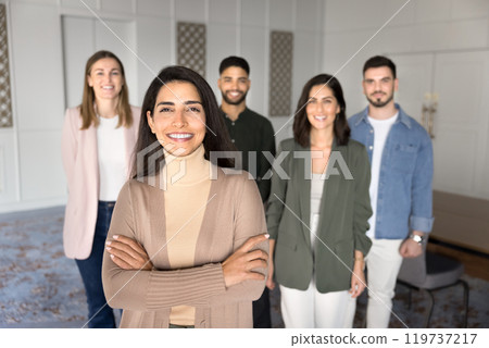 Cheerful confident Hispanic company director woman posing in office Cheerful confident Hispanic company director woman posing in office 119737217