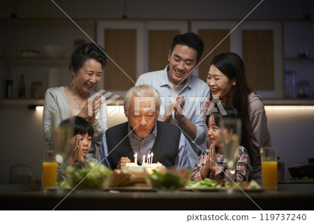 three generation asian family celebrating grandpa's birthday at home 119737240