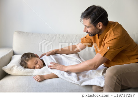 Caring father tucking up daughter sleeping on at daytime Caring father tucking up daughter sleeping on at daytime 119737287