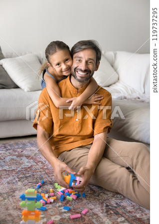 Happy sweet little daughter kid hugging cheerful Latin dad Happy sweet little daughter kid hugging cheerful Latin dad 119737295