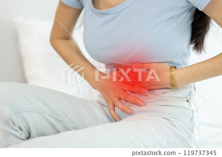 woman sitting on bed stomach ache. Have stomachache, menstrual disorders, food allergies, food poisoning, body aches and pains.  gastritis, diarrhea, enteritis. woman sitting on bed stomach ache. Have stomachache, menstrual disorders, food allergies, food poisoning, body aches and pains.  gastritis, diarrhea, enteritis. 119737345