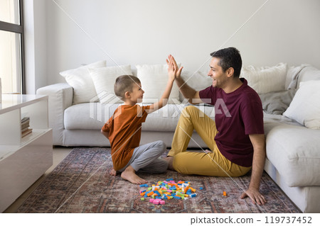 Cheerful father and cute son child clapping hands Cheerful father and cute son child clapping hands 119737452