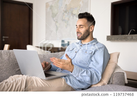 Handsome young Hispanic man talking on work conference chat Handsome young Hispanic man talking on work conference chat 119737468