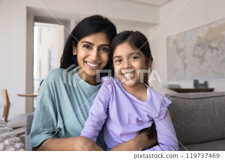 Happy young Indian mother holding sweet daughter kid on lap 119737469