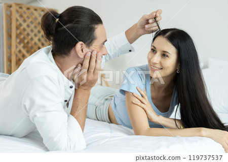 happy man woman couple romantic lying together lover on bed. 119737537