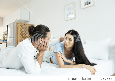 happy man woman couple romantic lying together lover on bed. happy man woman couple romantic lying together lover on bed. 119737538