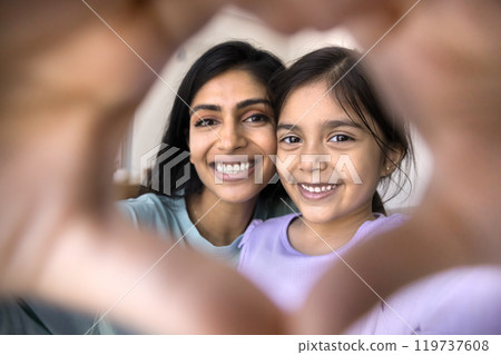 Happy Indian mom and kid looking at camera through heart Happy Indian mom and kid looking at camera through heart 119737608
