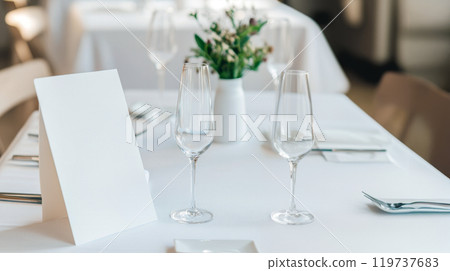 Elegant dining setup with floral centerpiece during afternoon Elegant dining setup with floral centerpiece during afternoon 119737683