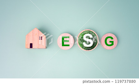 Wooden home and circular wooden board with the abbreviation ESG printed on a light green background, ESG concepts for sustainable environment, Society and governance is environmentally responsible. Wooden home and circular wooden board with the abbreviation ESG printed on a light green background, ESG concepts for sustainable environment, Society and governance is environmentally responsible. 119737880