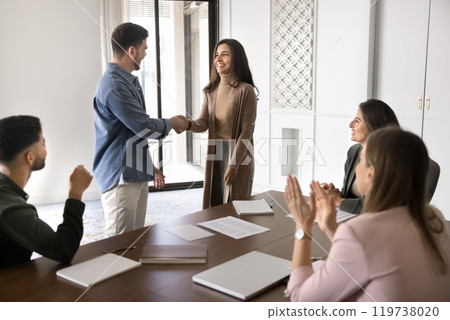 Positive couple of business partners shaking hands Positive couple of business partners shaking hands 119738020