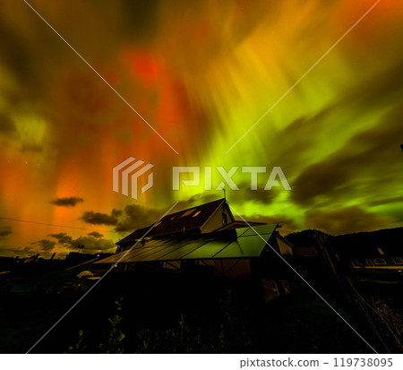 The Aurora Borealis, the northern lights, showing up above bungalow in County Donegal, Ireland 119738095