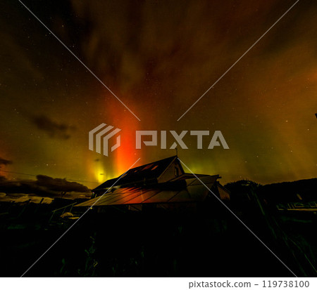 The Aurora Borealis, the northern lights, showing up above bungalow in County Donegal, Ireland 119738100