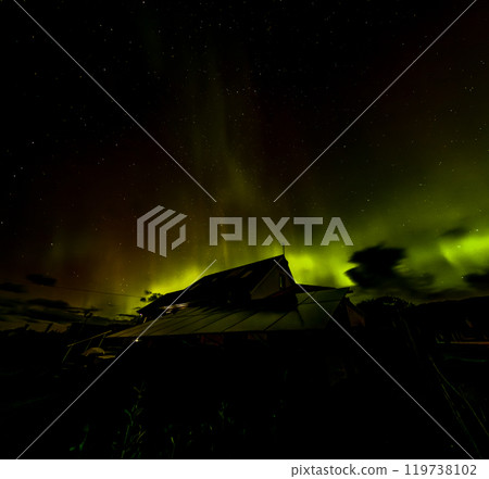 The Aurora Borealis, the northern lights, showing up above bungalow in County Donegal, Ireland 119738102