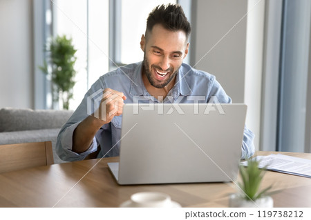 Cheerful excited young entrepreneur man making winner hand Cheerful excited young entrepreneur man making winner hand 119738212