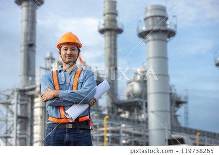 Portrait of asian worker power plant factory holding blueprint arms crossed. Engineer wearing safety uniform helmet. man electrical generator repair operations. Worker petrochemical energy. 119738265