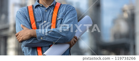 Portrait of asian worker power plant factory holding blueprint arms crossed. Engineer wearing safety uniform helmet. man electrical generator repair operations. Worker petrochemical energy. 119738266