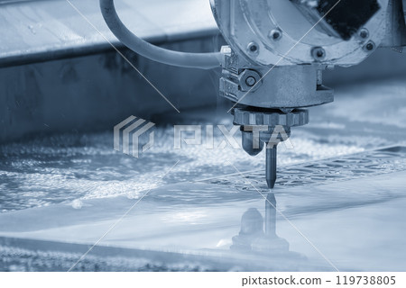 Close-up scene of multi-axis abrasive waterjet cutting machine cutting the aluminum plate. Close-up scene of multi-axis abrasive waterjet cutting machine cutting the aluminum plate. 119738805