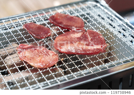Barbecue cooking scene. Beef tongue, beef. Barbecue cooking scene. Beef tongue, beef. 119738946
