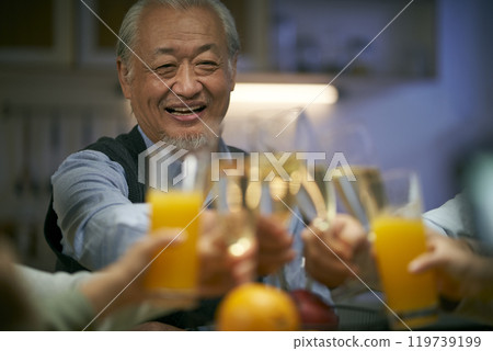 elderly asian man having a toast at dinner elderly asian man having a toast at dinner 119739199