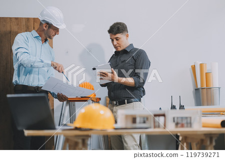 Team Engineers with draft plan of building on constructing site. Engineer work on site. engineer visit and inspection site engineer. Inspector engineer check and working on site. 119739271