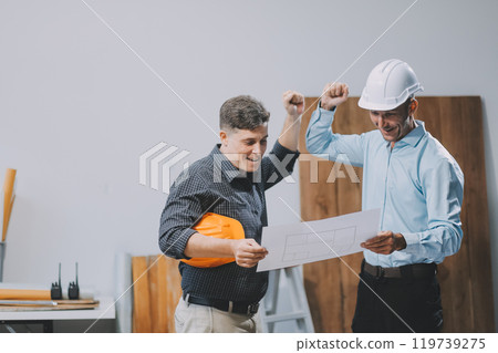 Team Engineers with draft plan of building on constructing site. Engineer work on site. engineer visit and inspection site engineer. Inspector engineer check and working on site. Team Engineers with draft plan of building on constructing site. Engineer work on site. engineer visit and inspection site engineer. Inspector engineer check and working on site. 119739275