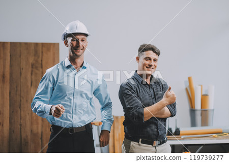 Team Engineers with draft plan of building on constructing site. Engineer work on site. engineer visit and inspection site engineer. Inspector engineer check and working on site. Team Engineers with draft plan of building on constructing site. Engineer work on site. engineer visit and inspection site engineer. Inspector engineer check and working on site. 119739277