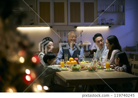 three generation asian family having christmas dinner together at home 119740245