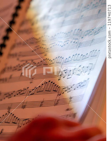 Music sheets. Melodies written with different musical symbols as background, closeup 119740713