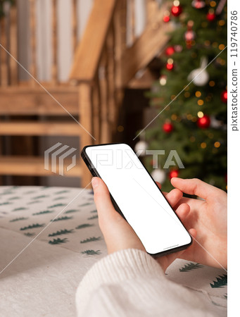 Hand holding mobile phone screen mockup, smartphone mock up, Christmas holiday and technology 119740786