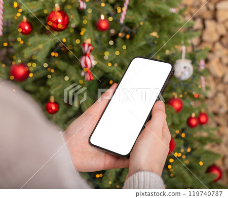 Hand holding mobile phone screen mockup, smartphone mock up, Christmas holiday and technology Hand holding mobile phone screen mockup, smartphone mock up, Christmas holiday and technology 119740787