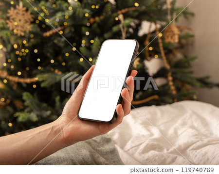 Hand holding mobile phone screen mockup, smartphone mock up, Christmas holiday and technology Hand holding mobile phone screen mockup, smartphone mock up, Christmas holiday and technology 119740789