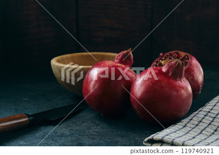 red ripe pomegranate fruits on dark background red ripe pomegranate fruits on dark background 119740921